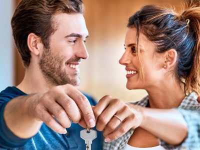 First time homebuyers holding keys to new house